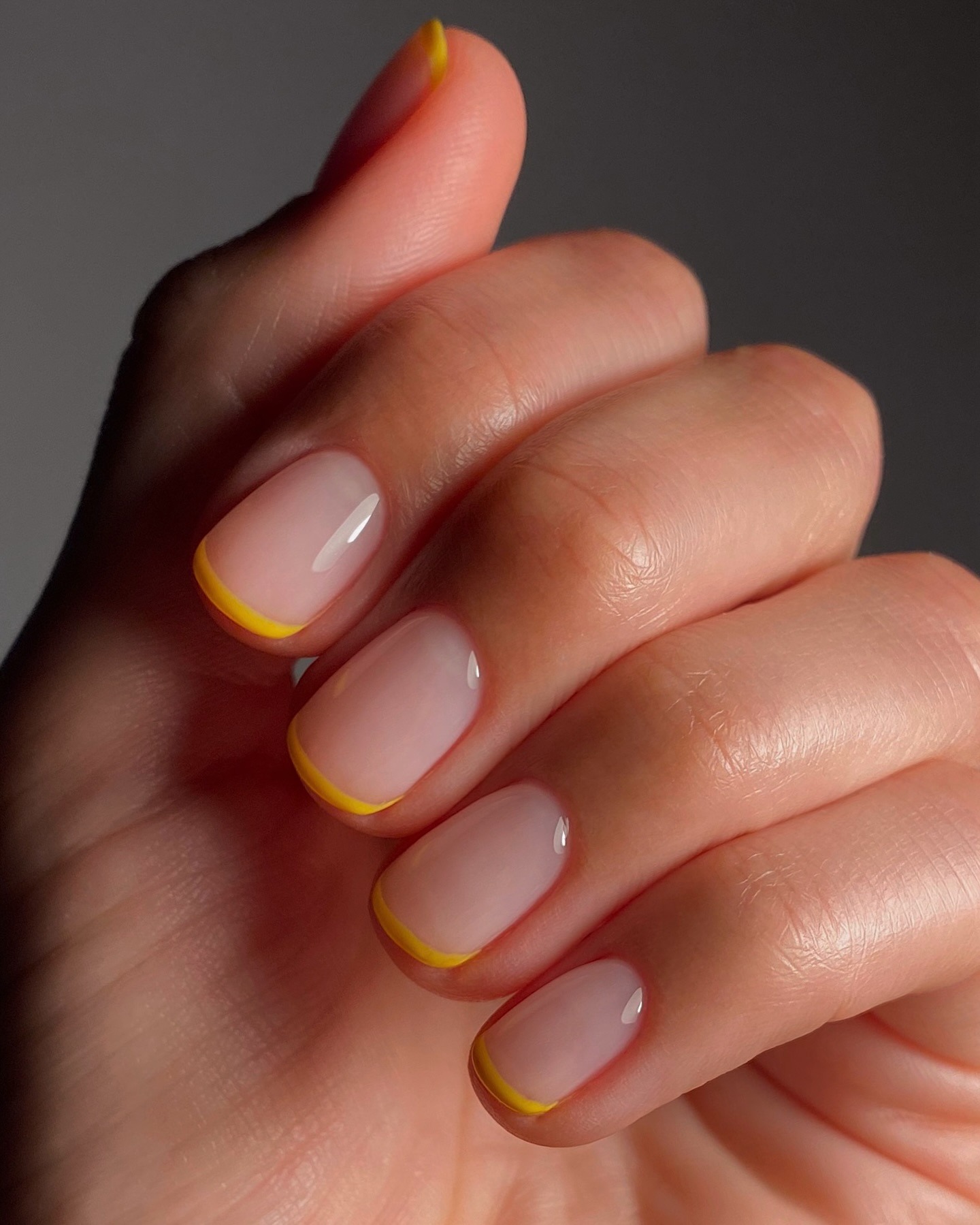 Clear nail polish with warm yellow French tips