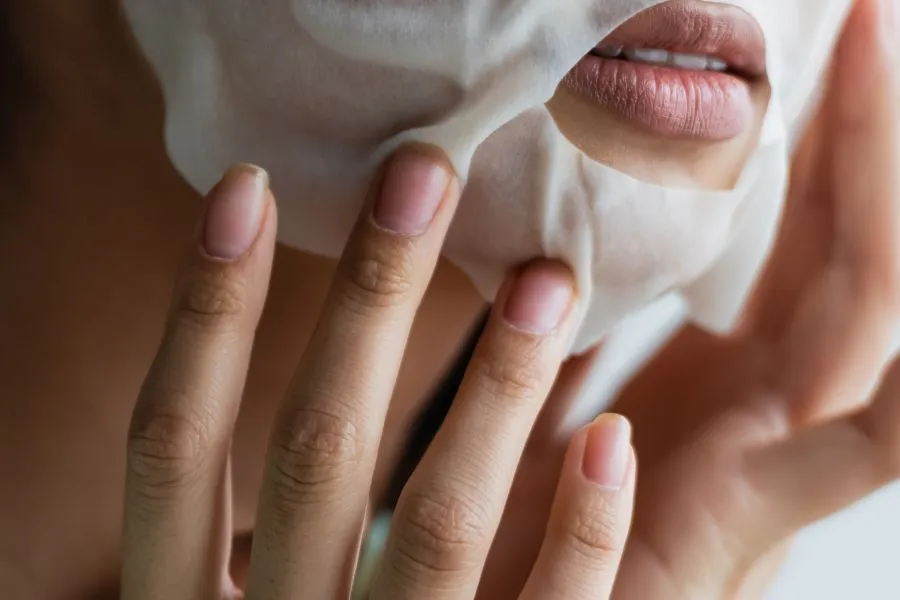 A woman wearing a sheet mask on her face