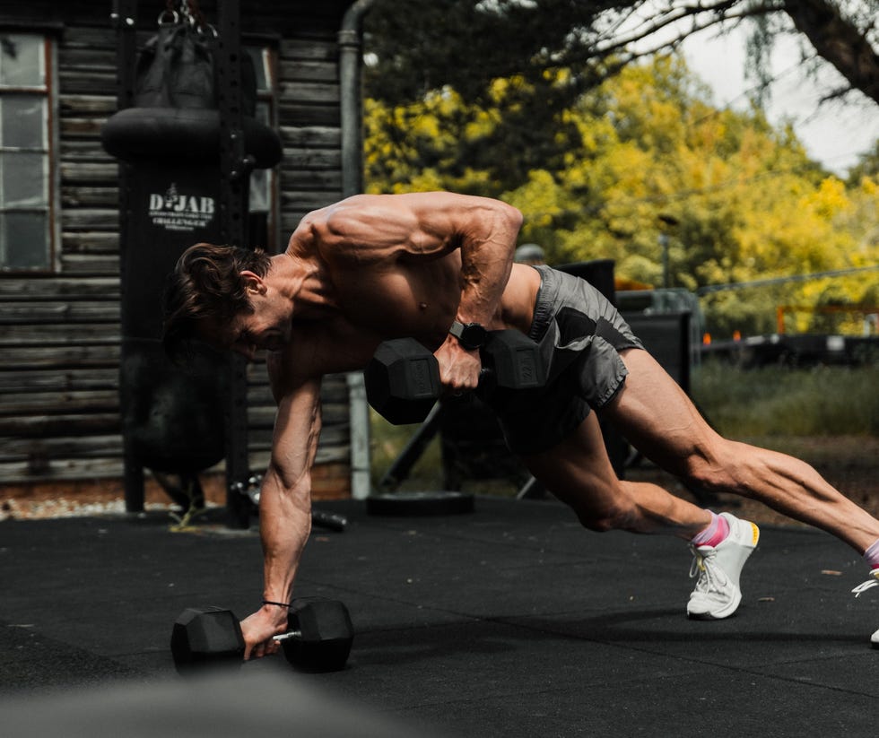 Man exercising with dumbbells outdoors
